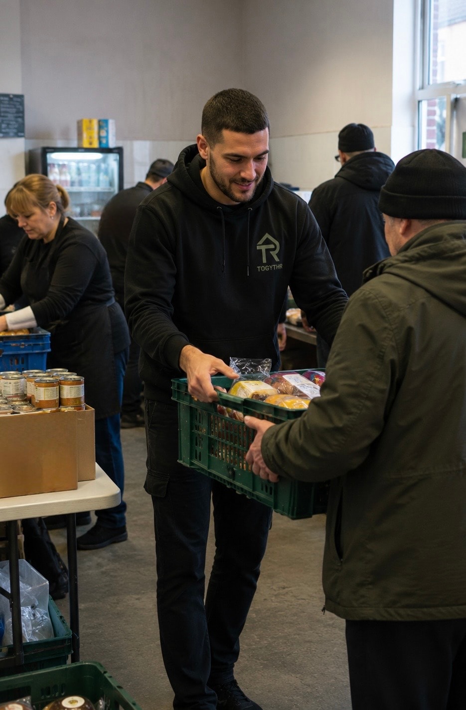 Togythr volunteer handing a food crate to a community member at a food distribution event